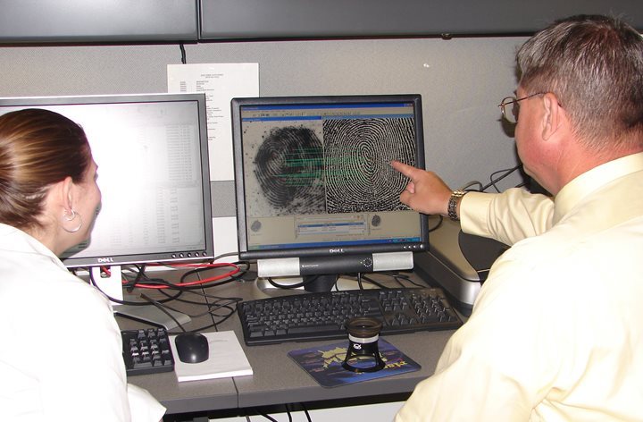 People looking at a finger print